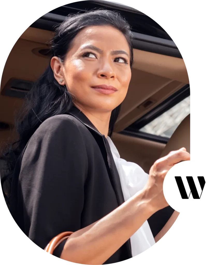 Woman stepping from luxury vehicle for private event